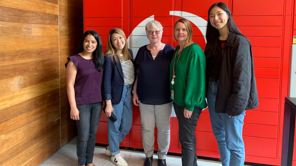 Photo of 5 women standing in front of Australia Post Parcel Lockers.